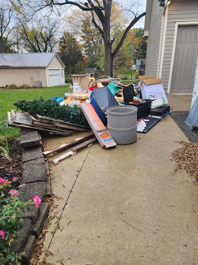 Dumpster being loaded with debris for Residential Dumpster Rental in Underwood-Petersville
